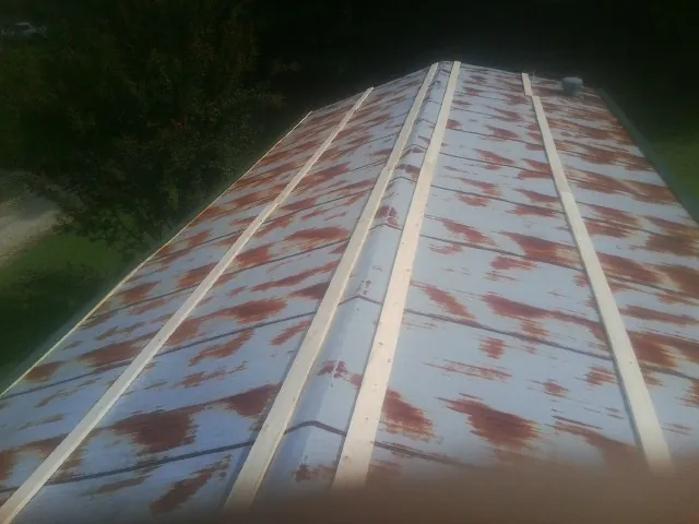 Rusted metal roof panels with new wood purlins before replacement — Storm Damage Roof Repair in Concrete by Roofing Brothers
